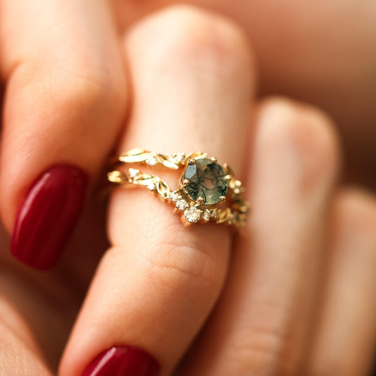 Round moss agate ring set in gold with leaf band and diamond accents