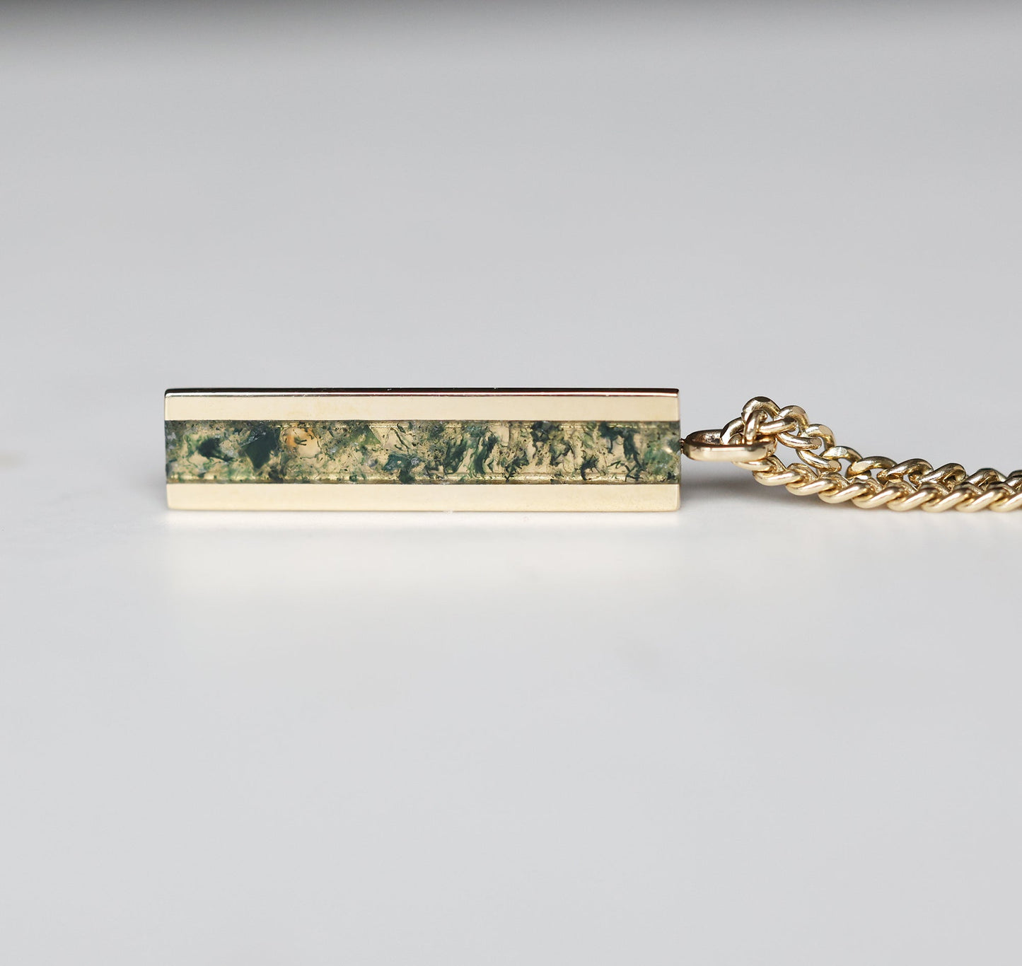 Muška bar ogrlica sa elegantnim priveskom od 14K zlata sa umetkom od Moss Agate, koji prikazuje prirodne zelene i zemljane šare na čvrstom lancu.