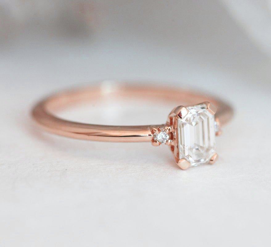 Smaragdno brušeni dijamantski prsten sa bočnim dijamantima, elegantnog i elegantnog dizajna od 14k žutog zlata.