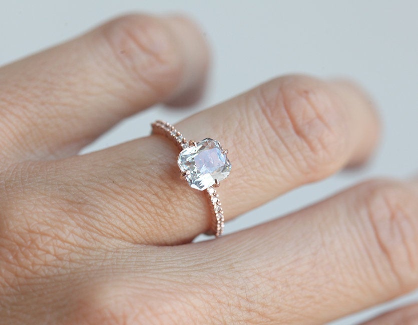 Radiant white sapphire ring with side diamonds