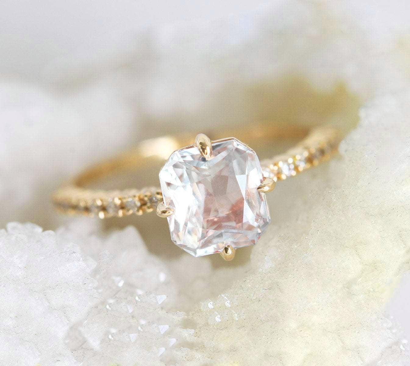 Radiant white sapphire ring with side diamonds