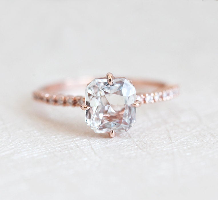 Radiant white sapphire ring with side diamonds