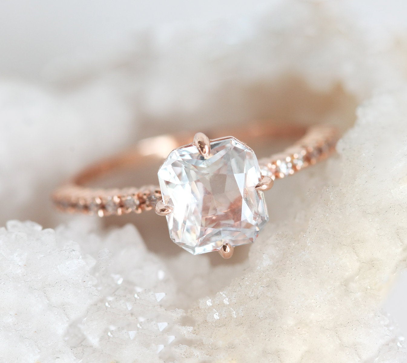 Radiant white sapphire ring with side diamonds