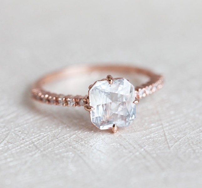 Radiant white sapphire ring with side diamonds
