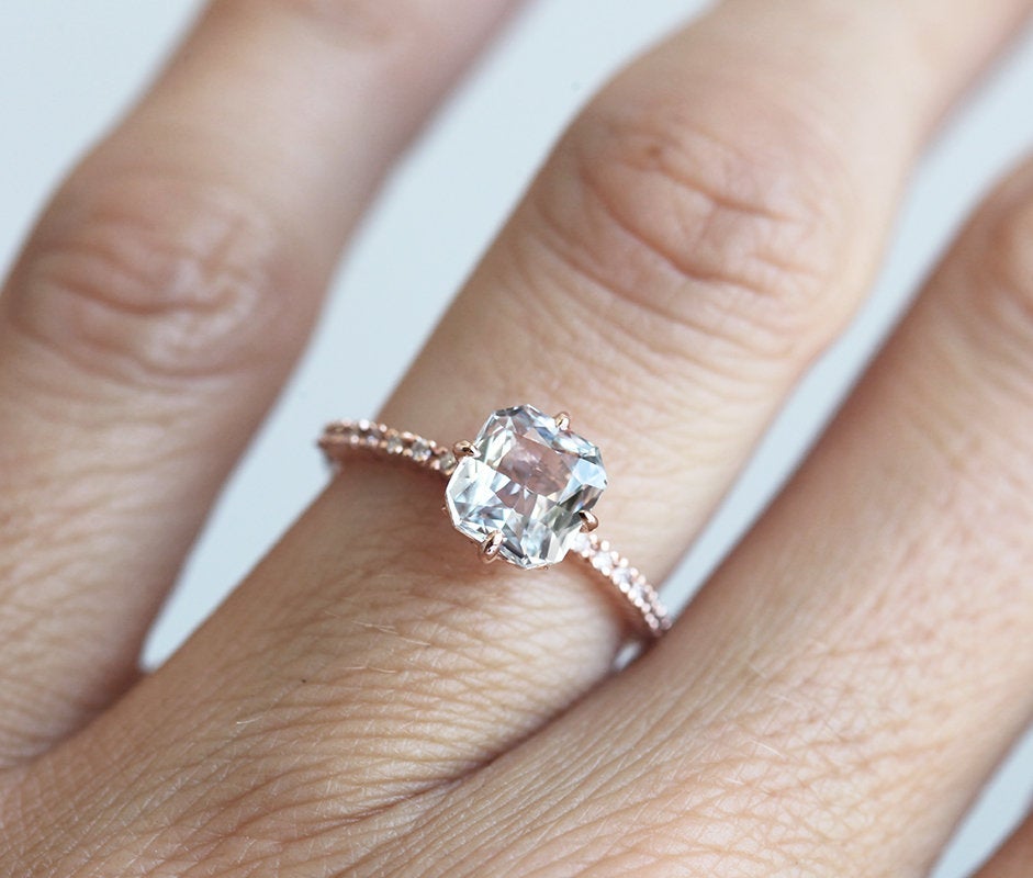 Radiant white sapphire ring with side diamonds