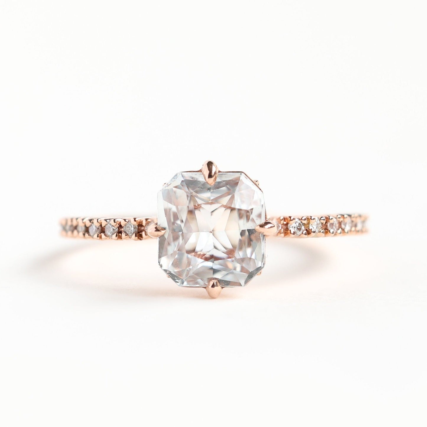 Radiant white sapphire ring with side diamonds