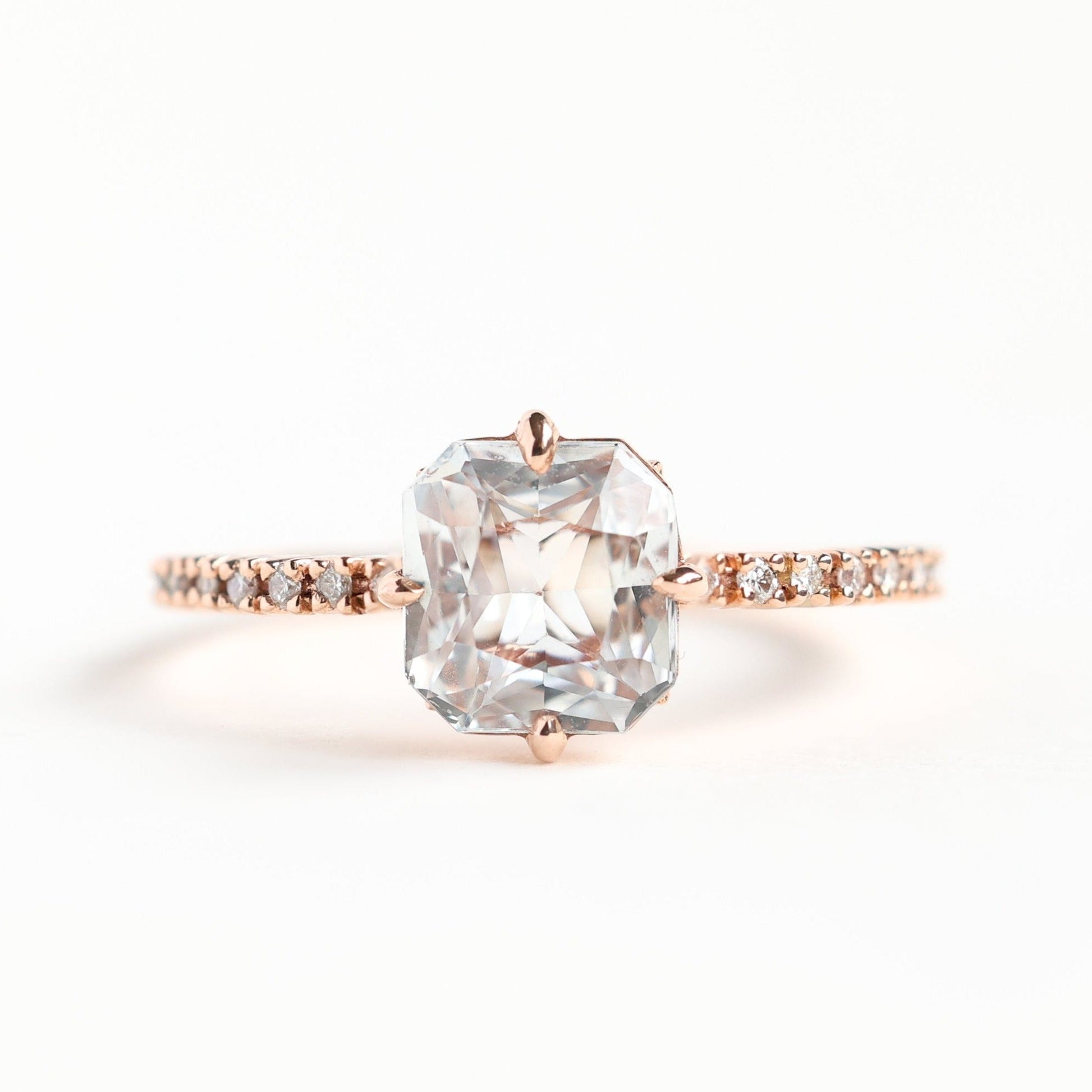 Radiant white sapphire ring with side diamonds